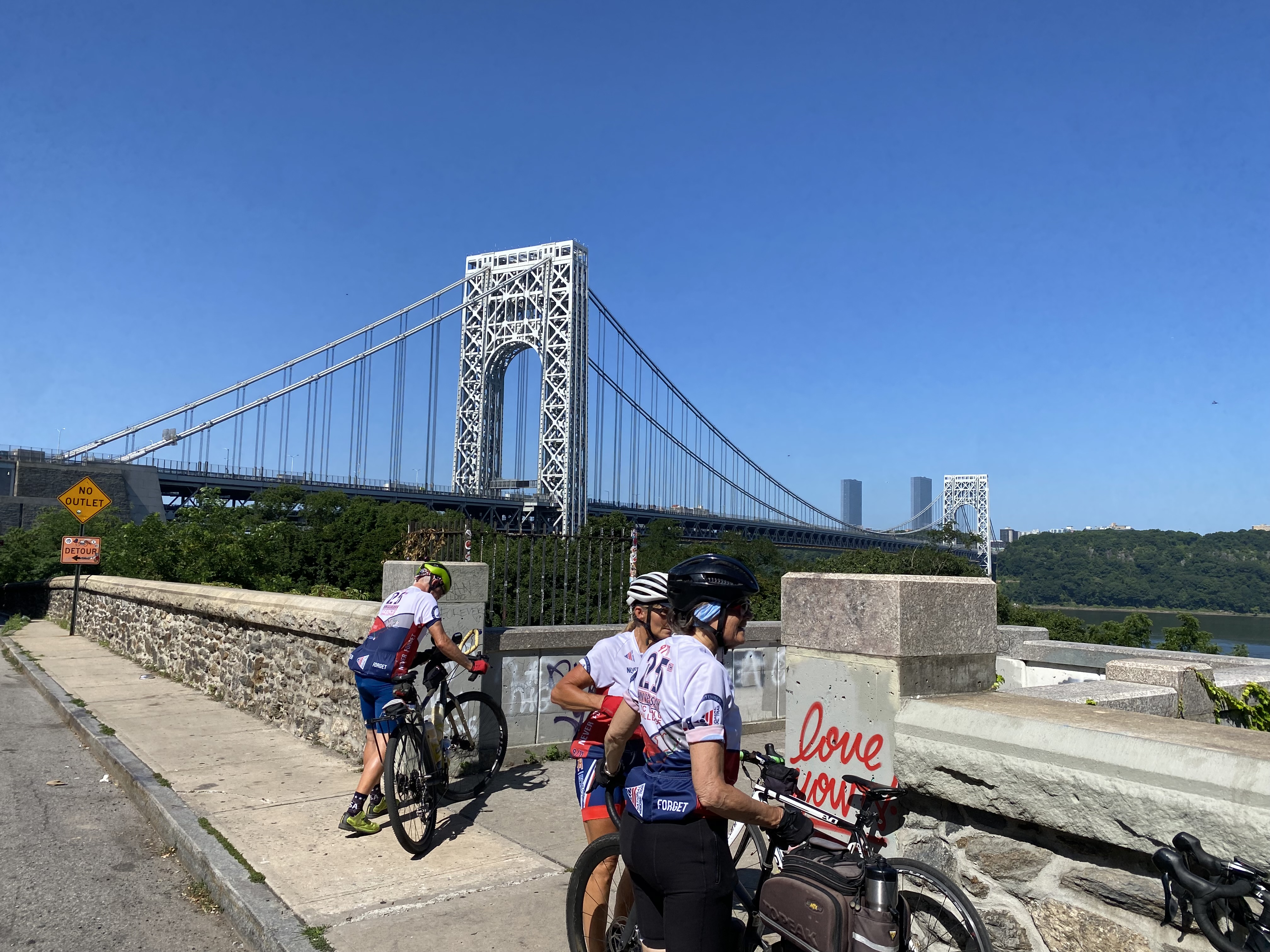 Cyclists pause alongside the George Washington Bridge